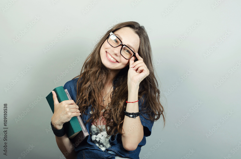 Young woman holding book on grey background Young woman holding book on grey background