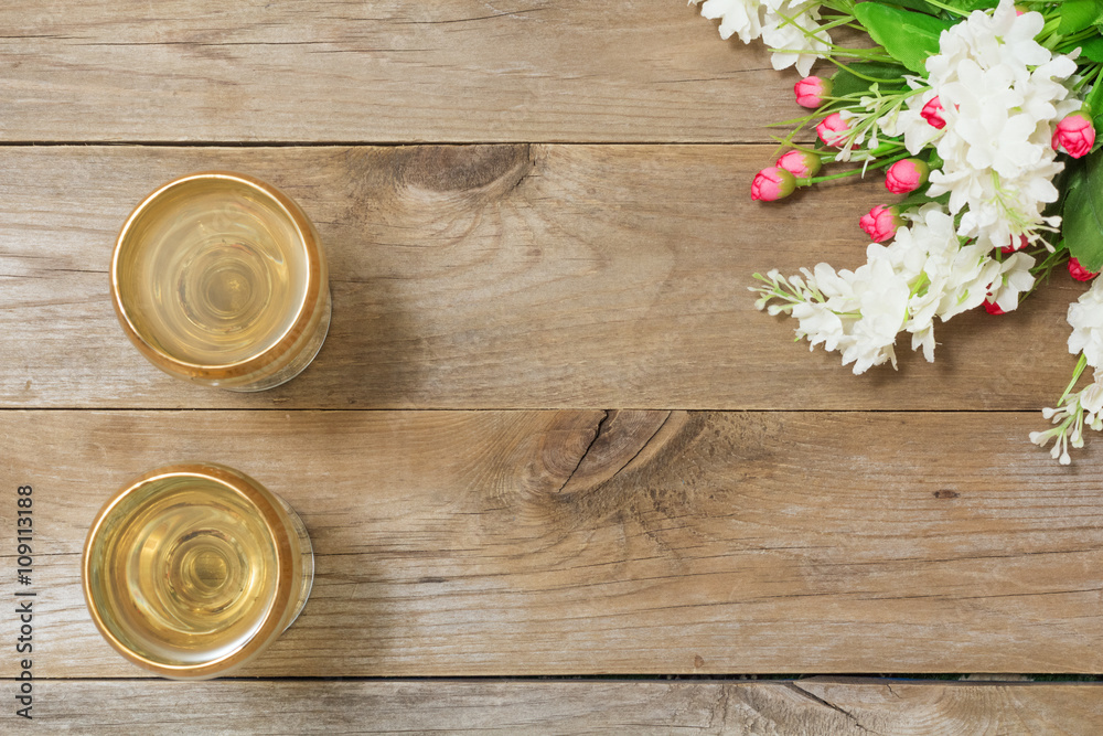Two glasses of white wine and flowers Two glasses of white wine and flowers