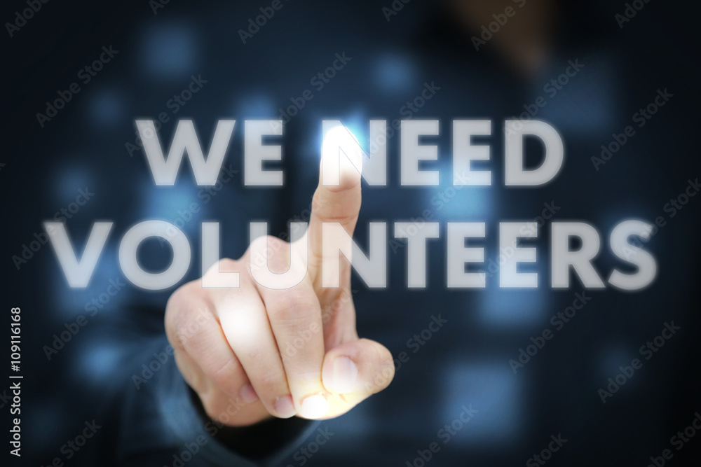 Businessman touching We Need Volunteers Businessman touching We Need Volunteers