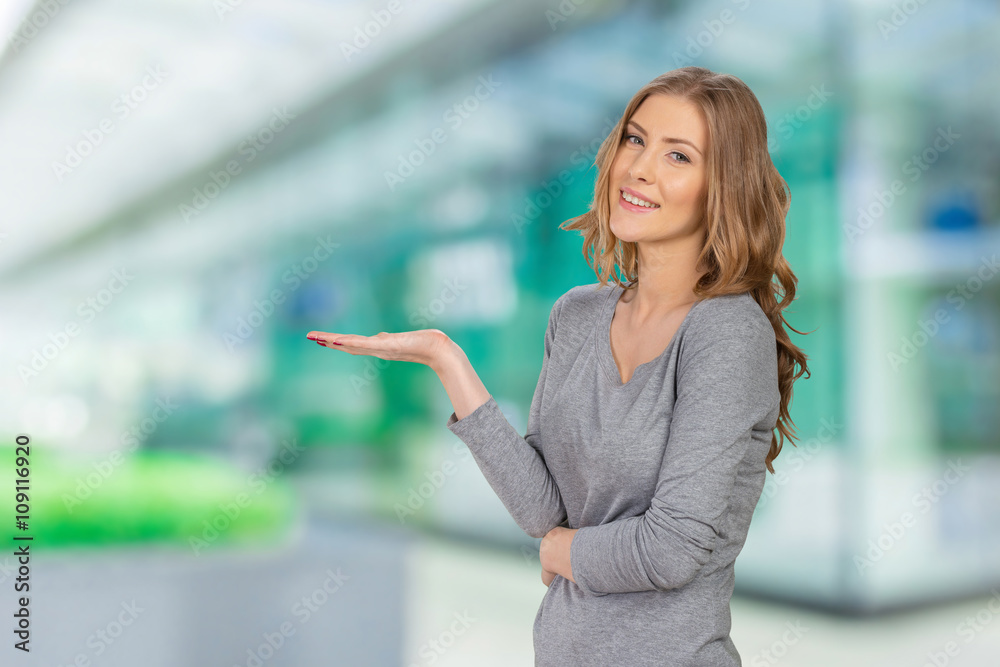 Young elegant woman pointing at white background