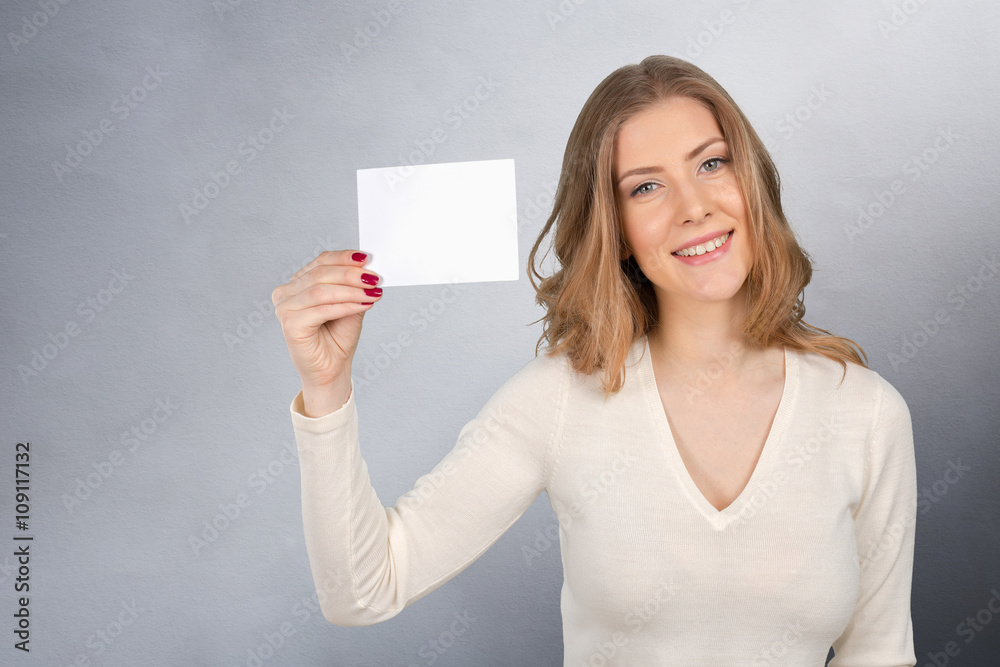 Businesswoman holding a blank business card Businesswoman holding a blank business card