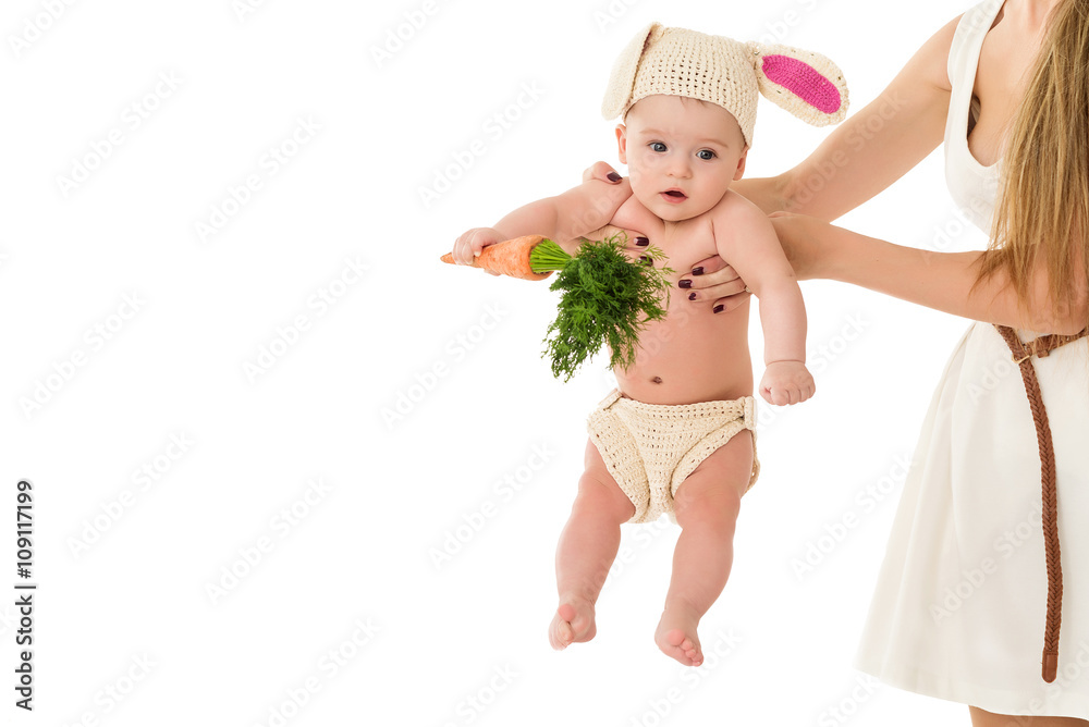 Mother hands hold baby in easter rabbit costume and carrot