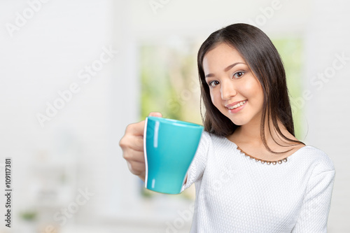 Portrait of young woman having coffee photo