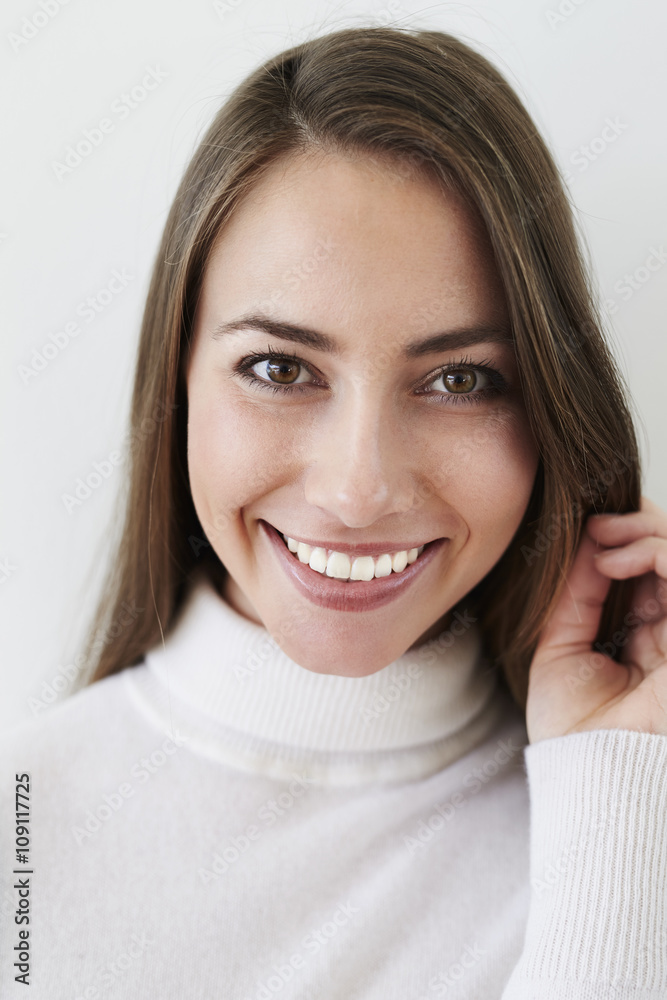 Smiling beauty in white polo neck, portrait Smiling beauty in white polo neck, portrait