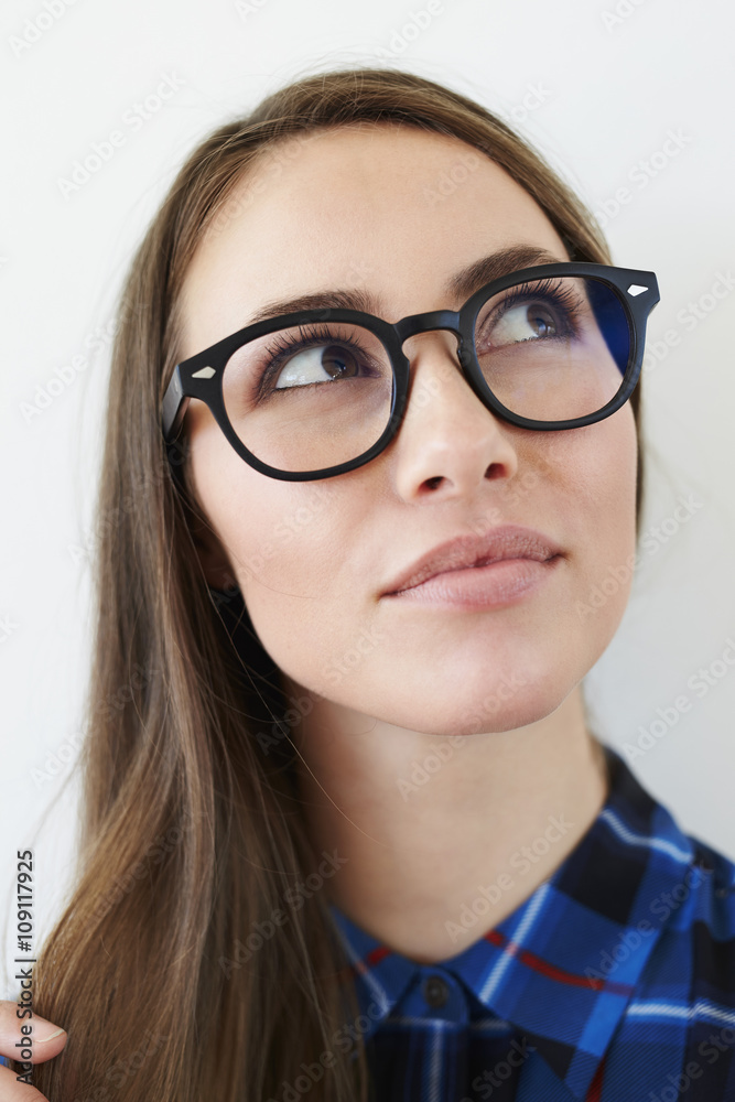 Spectacles on beautiful young woman, looking away