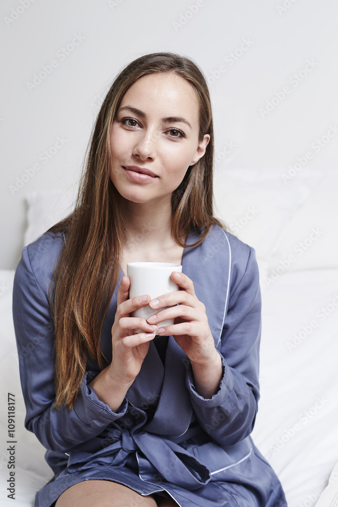 Portrait of beautiful woman in bathrobe on bed Portrait of beautiful woman in bathrobe on bed