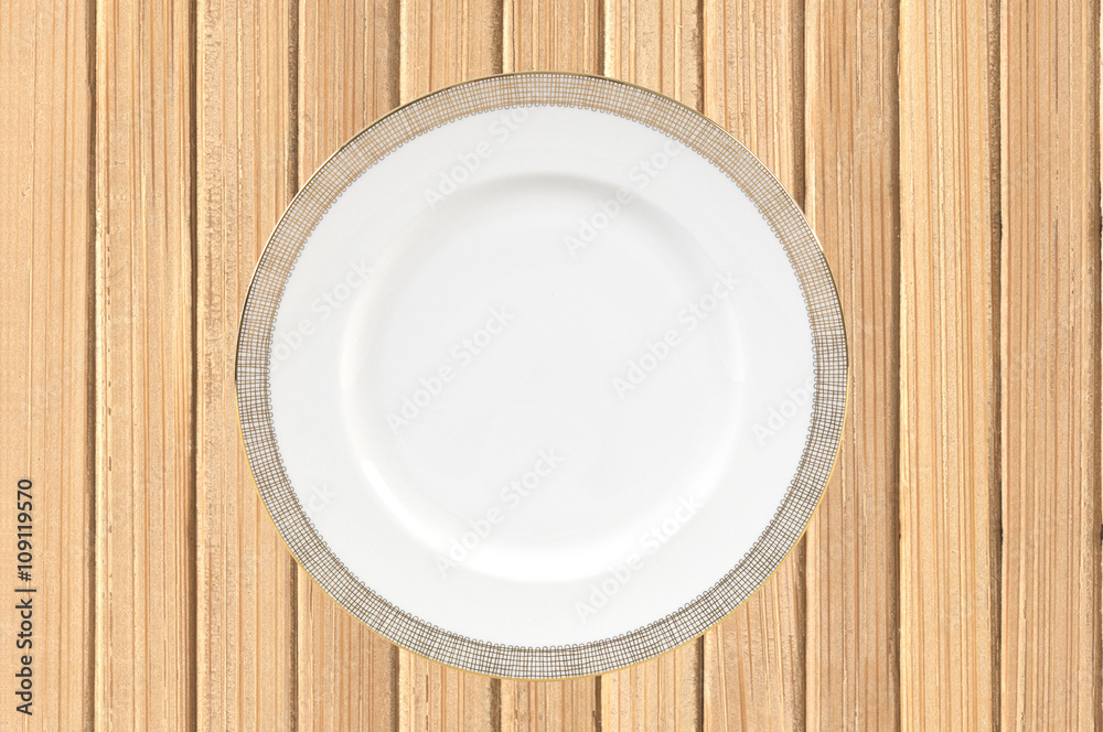 Empty plate on wooden background Empty plate on wooden background