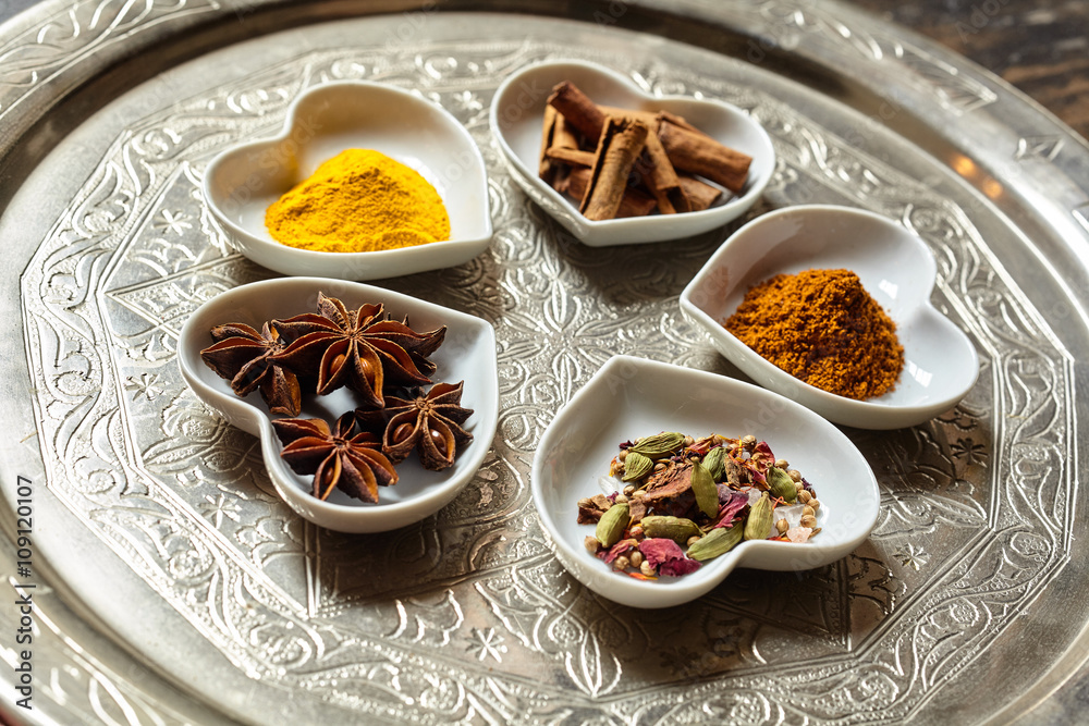 Asian spices in heart shaped dishes over plate Asian spices in heart shaped dishes over plate