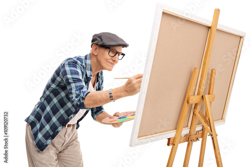 Senior painter painting on a canvas