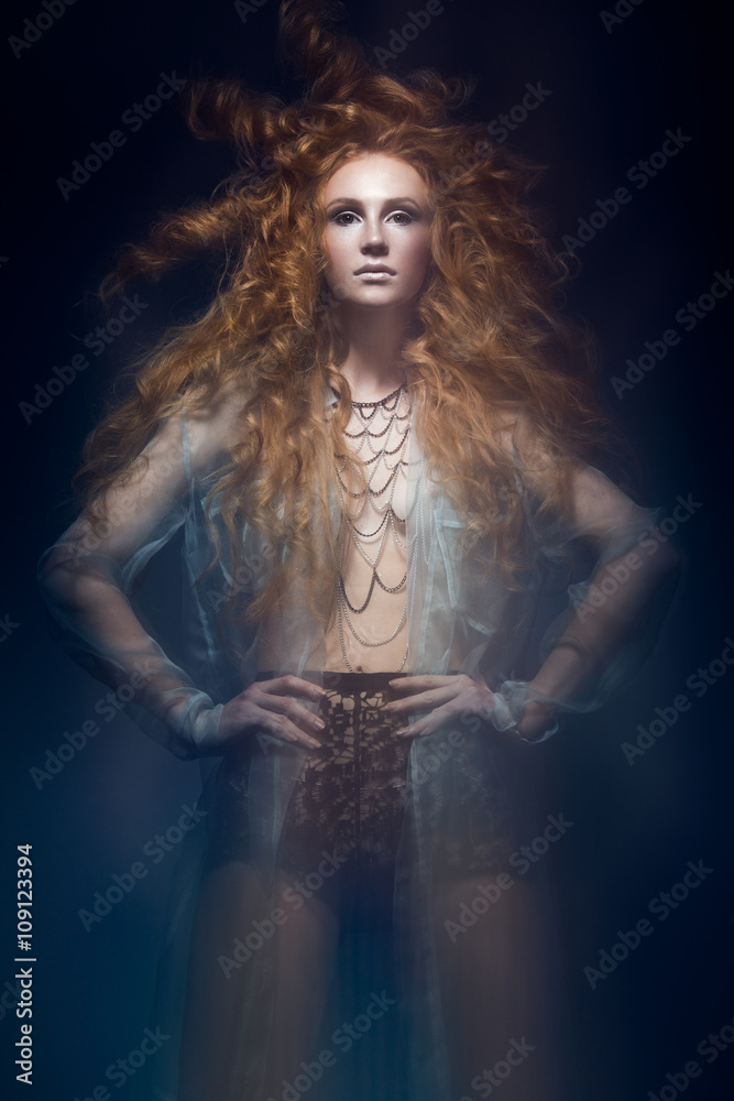Beautiful fashionable red-haired girl in transparent dress, mermaid image with creative hairstyle curls. Fashion beauty style. Beautiful fashionable red-haired girl in transparent dress, mermaid image with creative hairstyle curls. Fashion beauty style.