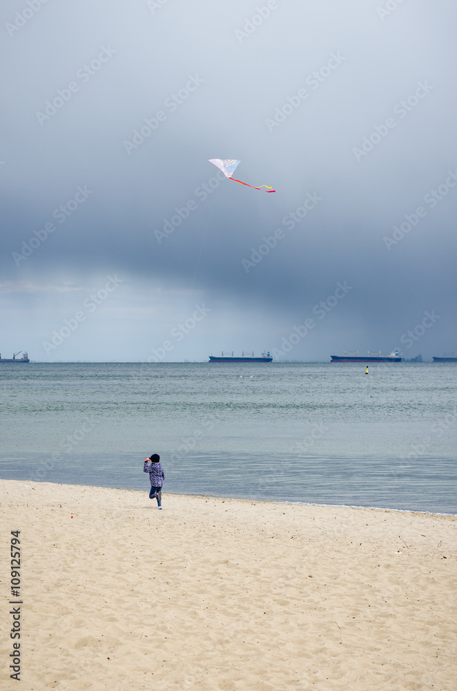 dziecko bawi się latawcem na plaży
 - obrazy, fototapety, plakaty 