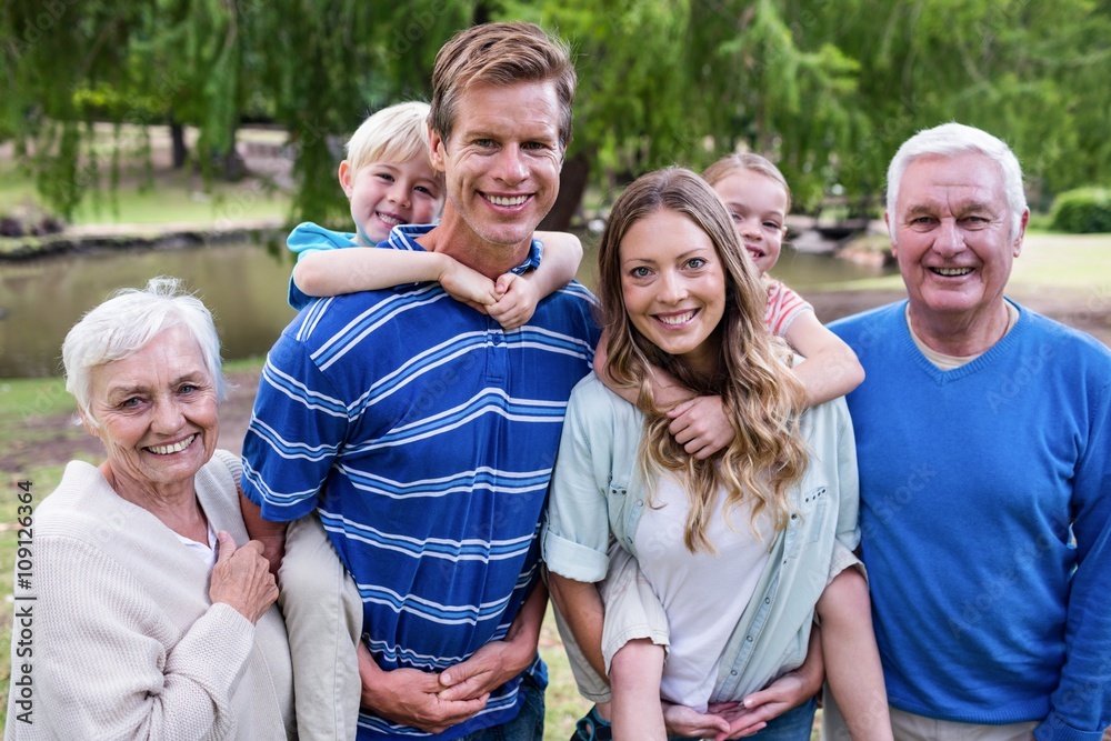 Multi-generation family standing in the park