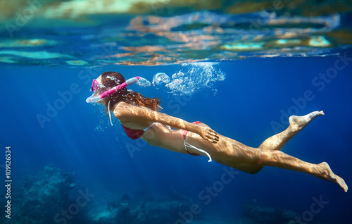 Woman swim underwater in tropical sea with mask