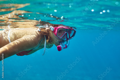 underwater portrait of young lady snorkeling in mask photo