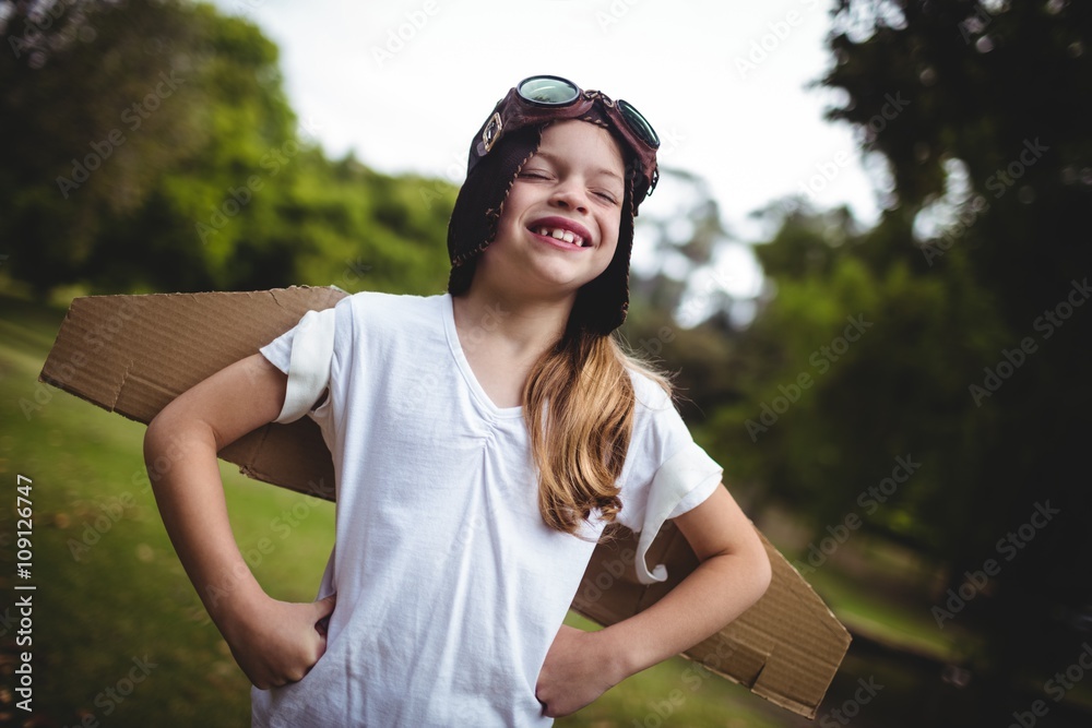 Happy girl standing in the park with hand on hip Happy girl standing in the park with hand on hip