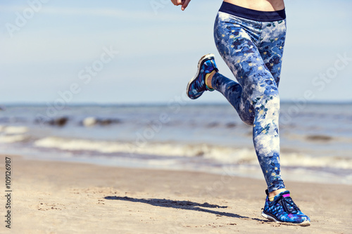 woman running on the beach, space for copy