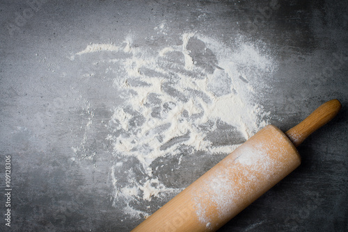 Flour and rolling pin on a stone table