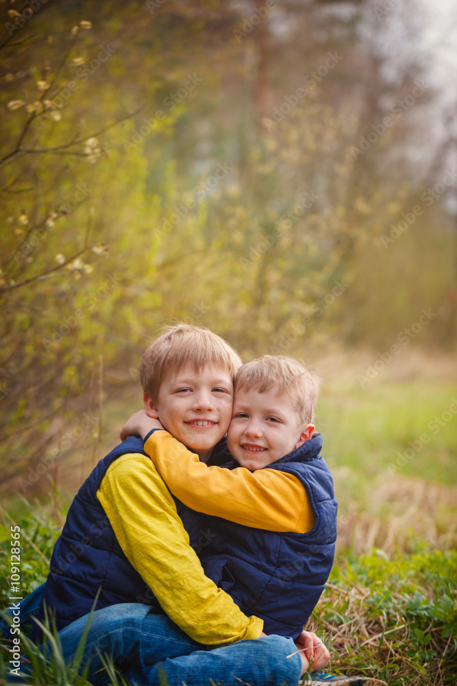 Portrait happy two brothers embracing in sunny day. Portrait happy two brothers embracing in sunny day.