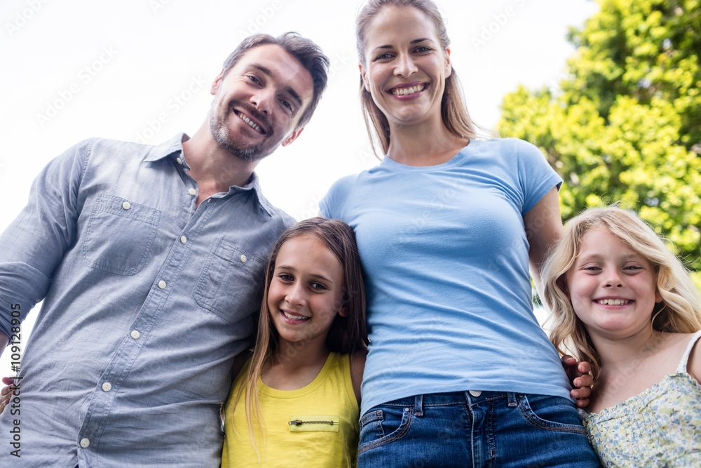 Happy family standing together with arm around Happy family standing together with arm around