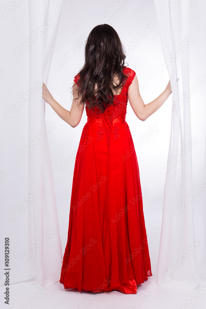 back view of slim woman in red dress over white back view of slim woman in red dress over white