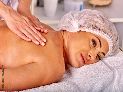 Woman middle-aged take back massage in spa salon .Womans middle-aged healthy lifestyle.