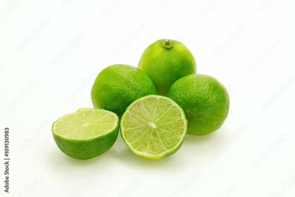 Close-up of several limes on white background