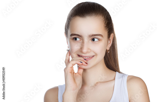 portrait of a pretty teen girl on a white background. Human emotions, girl thinks.