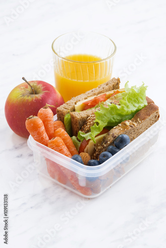 lunch box with sandwich of wholemeal bread, vertical