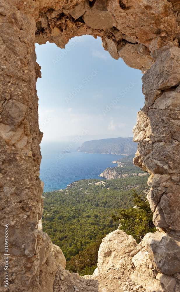 Nice view of the mountains and the coast of the Aegean Sea from the ruins of an ancient knight's castle Monolithos on the west coast of the island of Rhodes, Greece
