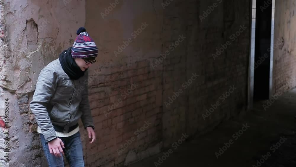 Teenage guy running fast in desolate backstreet, victim escaping from bullies Teenage guy running fast in desolate backstreet, victim escaping from bullies