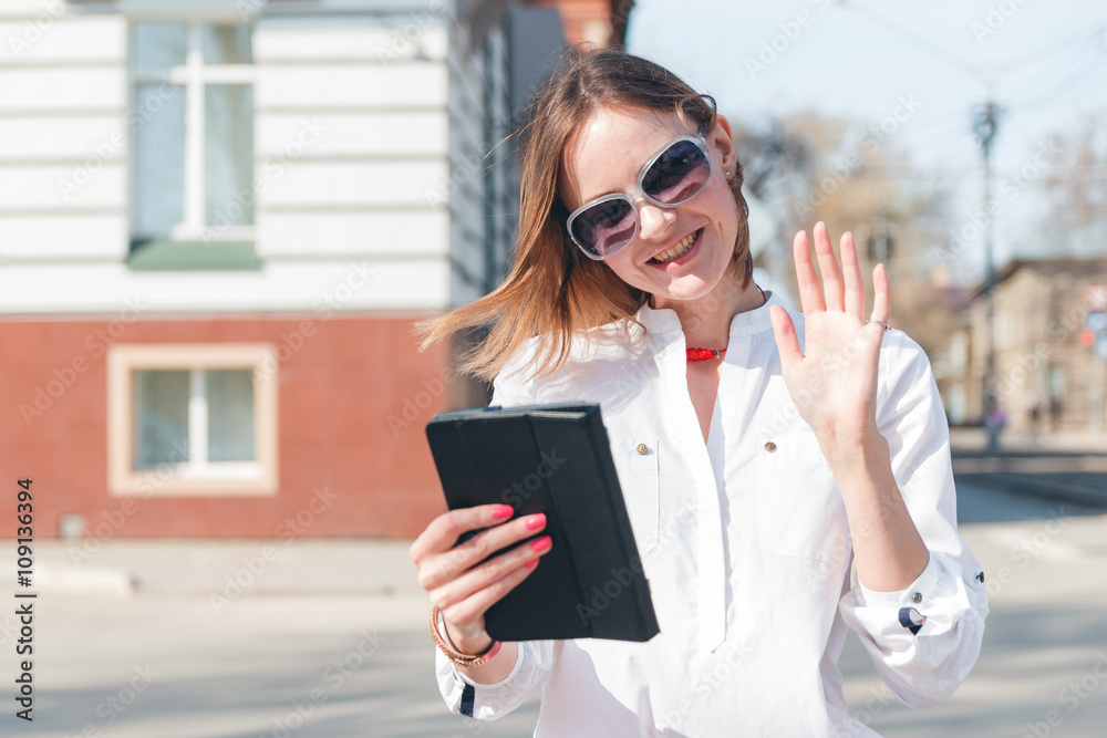 Fototapeta premium smiling girl touching tablet screen