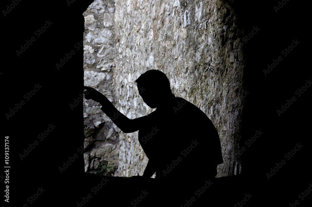 Silhouette of boy in tunnel