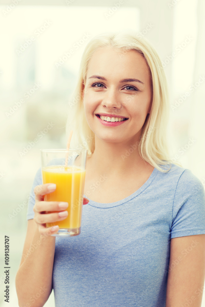 smiling woman drinking orange juice at home smiling woman drinking orange juice at home