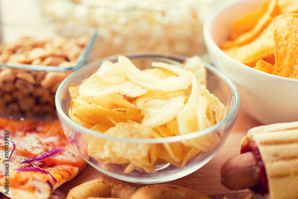 close up of crunchy potato crisps in glass bowl close up of crunchy potato crisps in glass bowl