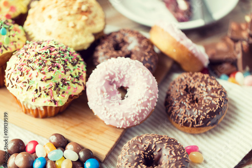 close up of glazed donuts and sweets on table