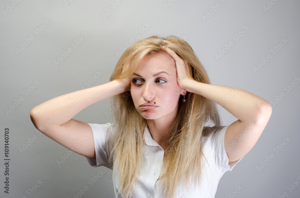 Teen woman with headache holding her hand to the head Teen woman with headache holding her hand to the head