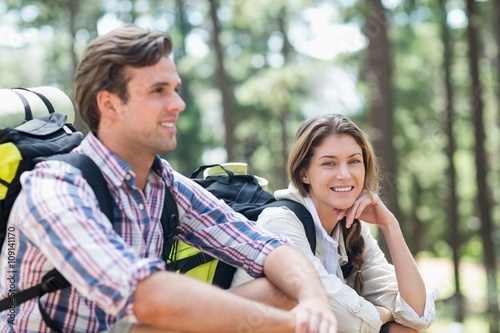 Portrait of woman sitting with partner during hiking 