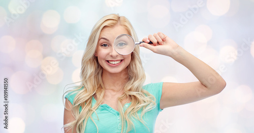 happy young woman with magnifying glass