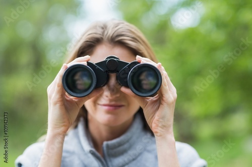 Close-up of beautiful woman with binocular 