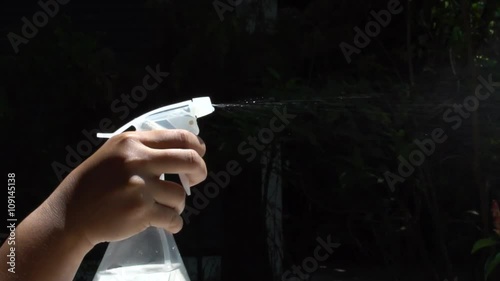 Using spraying bottle and cleaning on black background shooting with high speed camera 120 FPS. photo