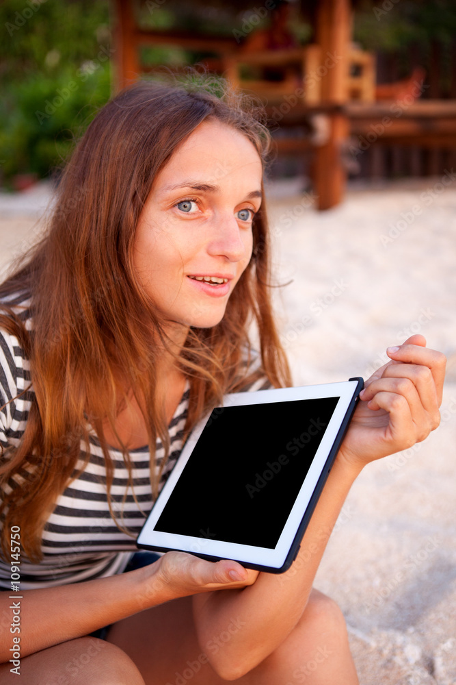 Fototapeta premium Beautiful girl working on the tablet