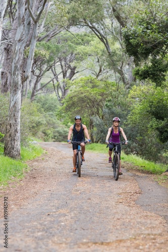 Man and woman riding bike in forest © WavebreakmediaMicro