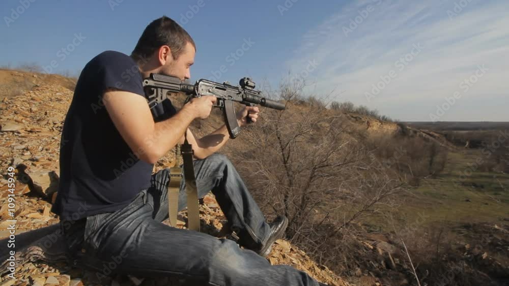 man firing customised russian machine gun, wide man firing customised russian machine gun, wide