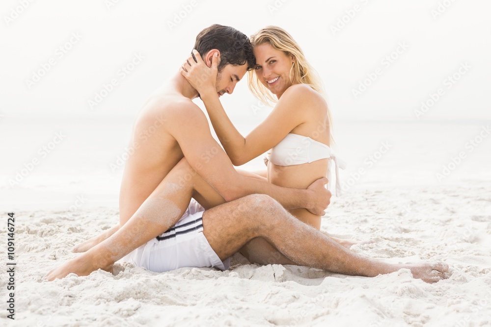 Fototapeta premium Happy couple sitting and embracing