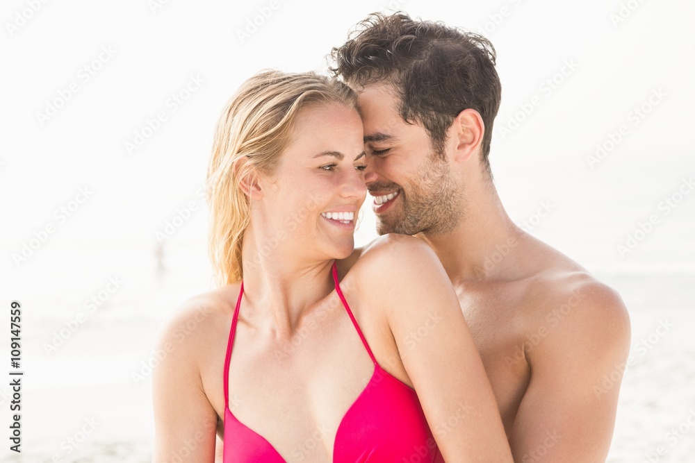 Happy couple embracing on the beach