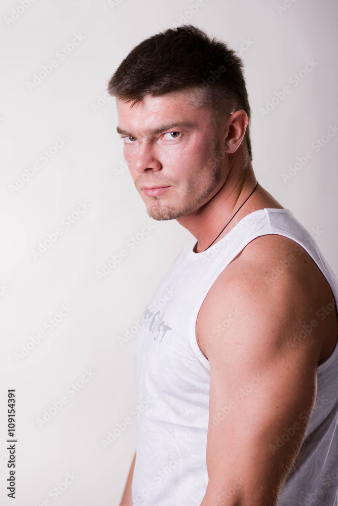 Bodybuilder showing his back and biceps muscles, personal fitness trainer. Strong man flexing his muscles Bodybuilder showing his back and biceps muscles, personal fitness trainer. Strong man flexing his muscles