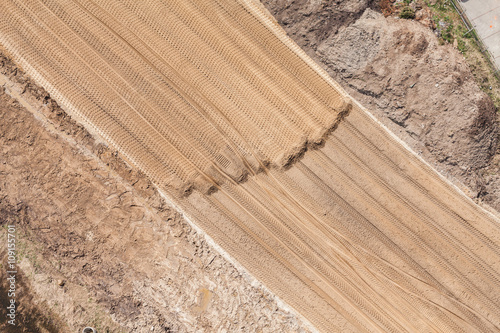 Aerial view of the earth mover tracks on sand