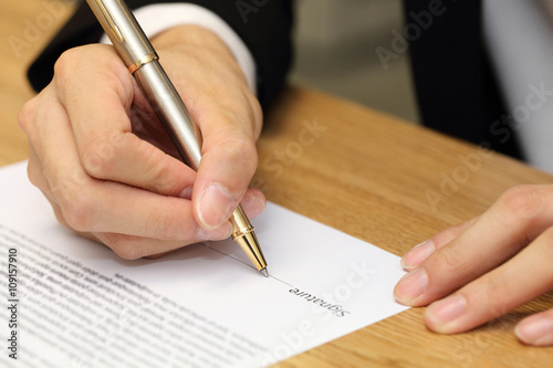 businessman hand signing a contract paper © charnsitr