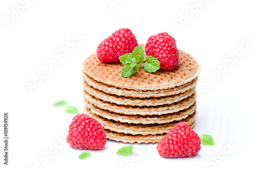Stack of Dutch caramel waffles with fresh raspberry and cup of