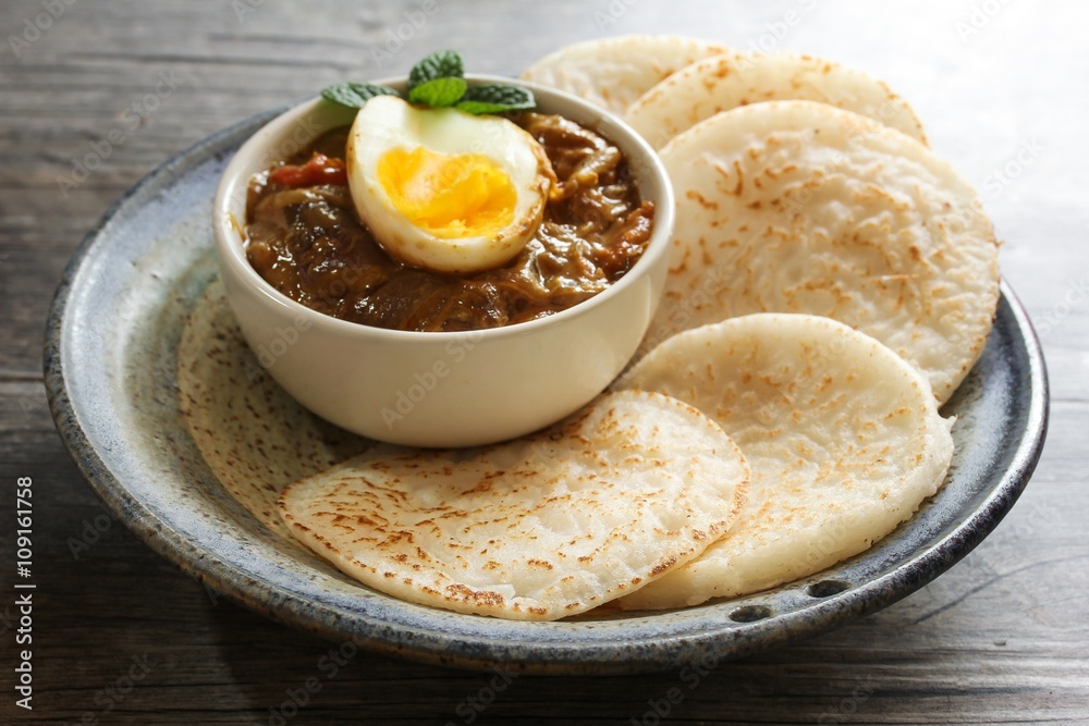 Appam and Egg curry / Savory Rice pancake , selective focus Appam and Egg curry / Savory Rice pancake , selective focus